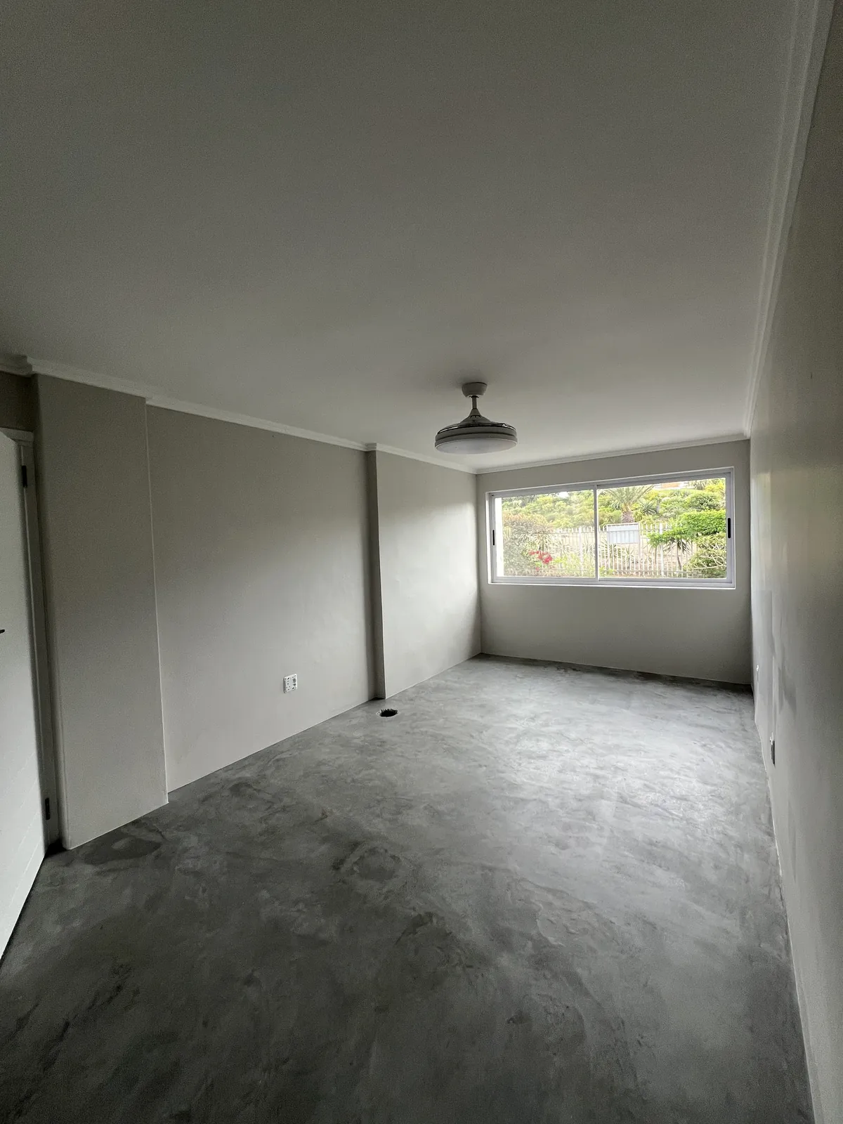 Bedroom with new microcement floor and fresh paint
