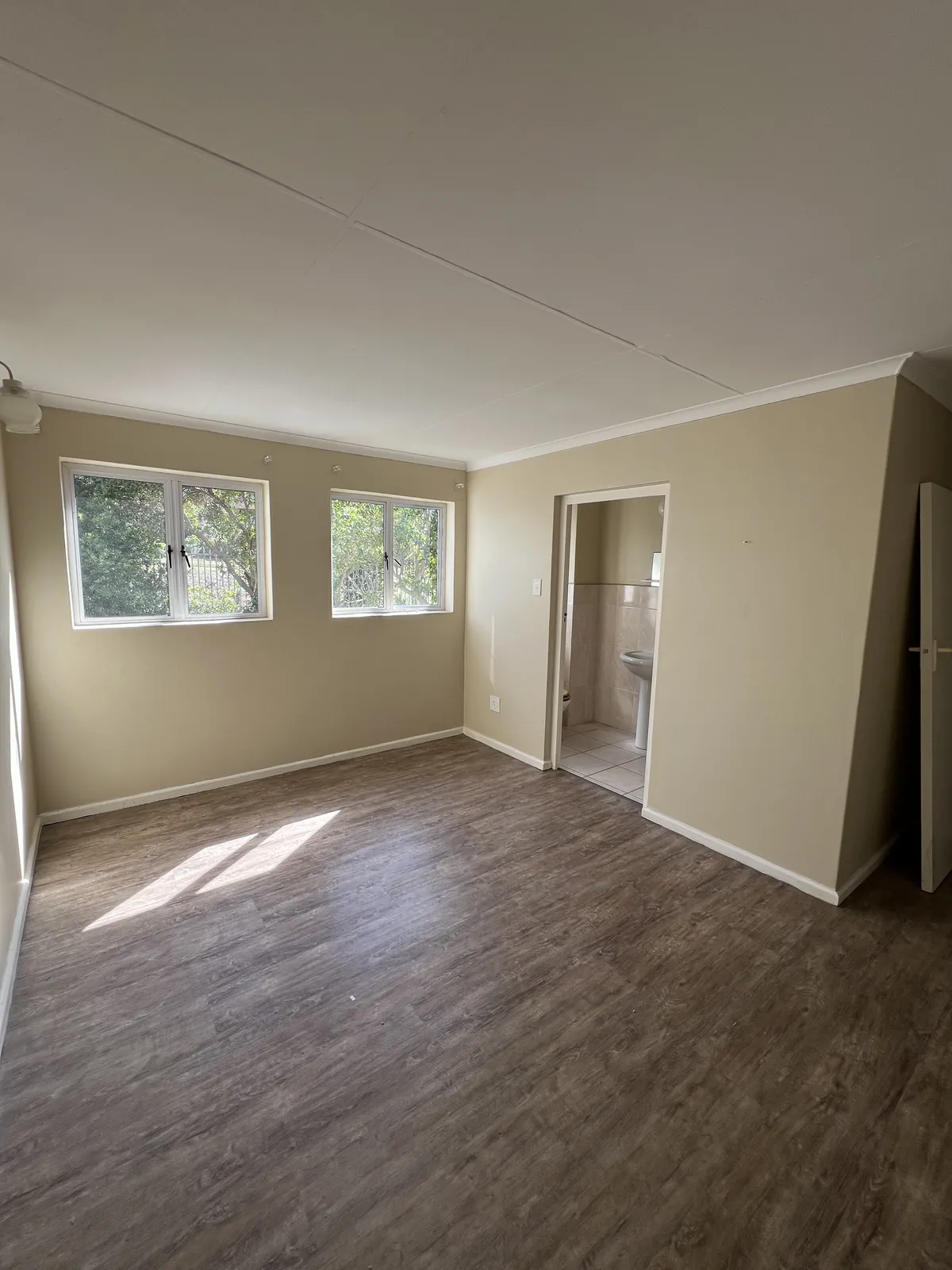 Before: a bedroom with the original laminate floor and finishes