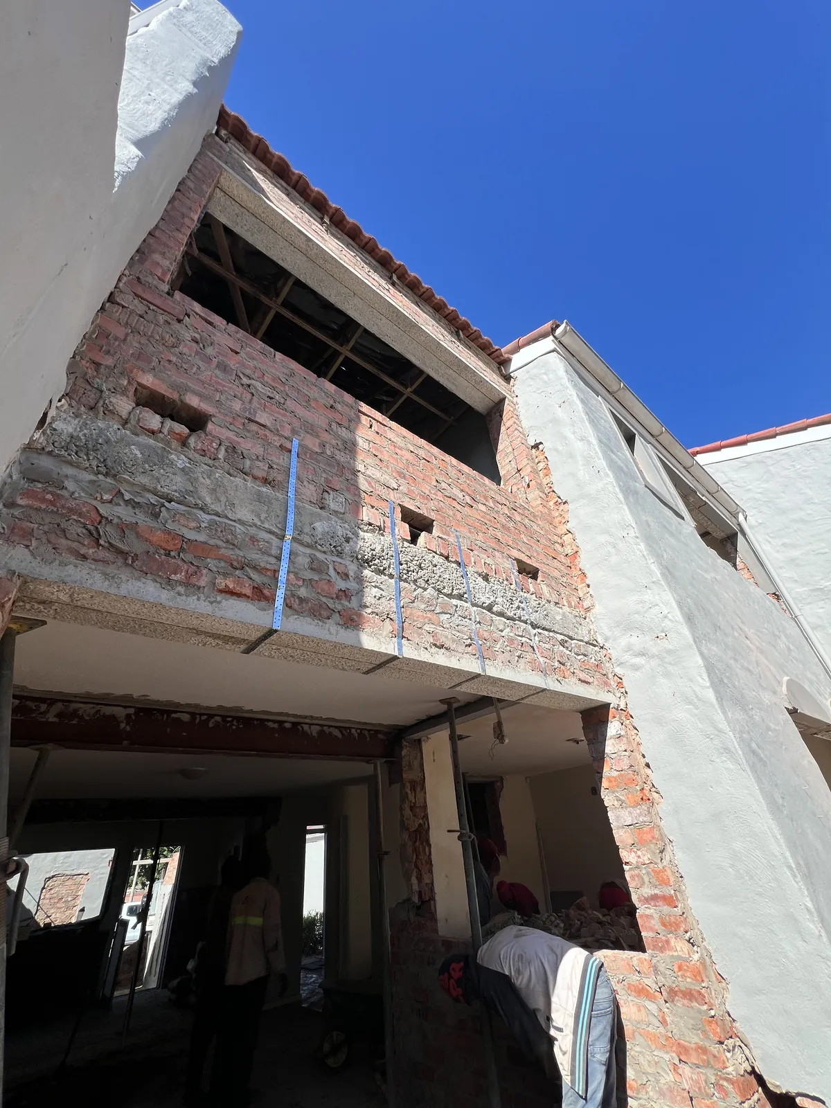 New brickwork enclosing the balcony, strapped into the existing structure