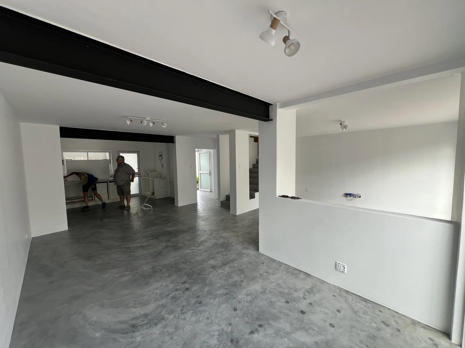 Exposed black steel beams where the old walls used to be