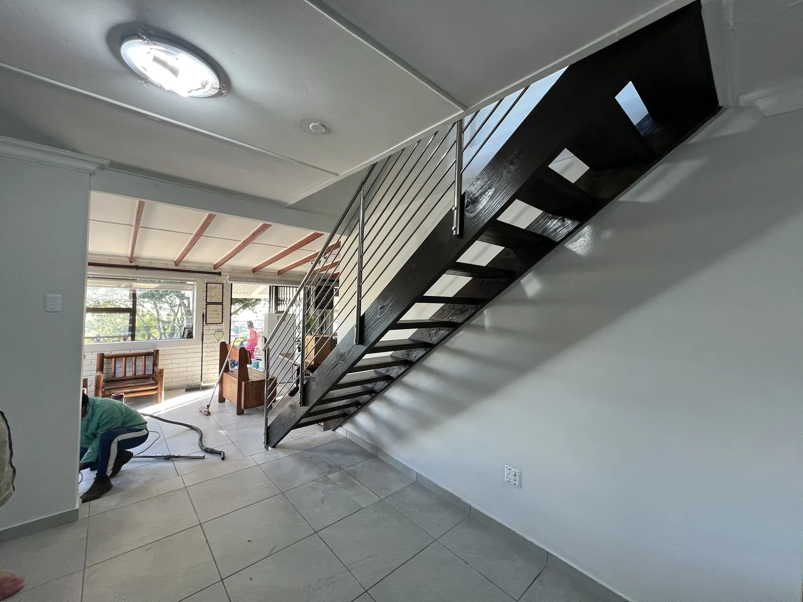 The new staircase with the open living area behind it