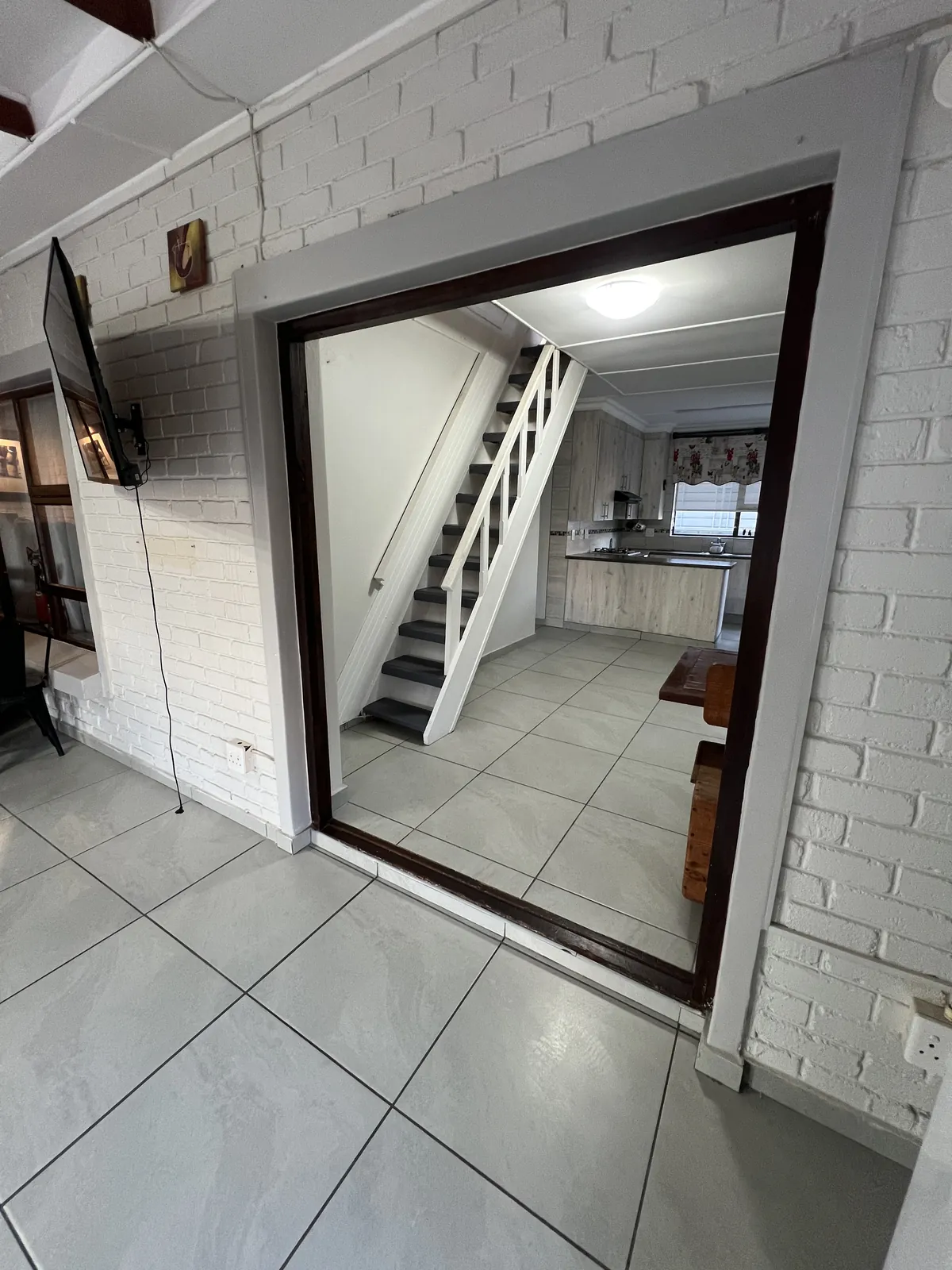 Before: the old stairs boxed in next to the kitchen