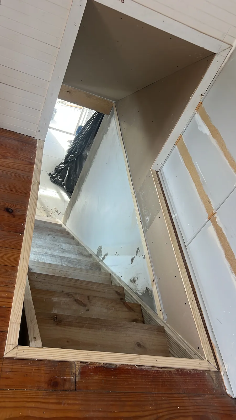 Wall broken through and the first floor cut back to make room for the new stairs