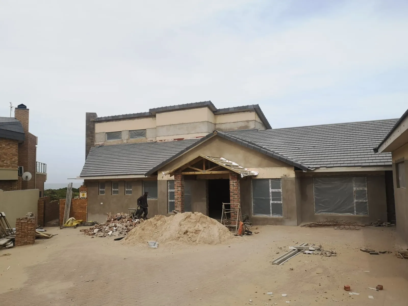 Before: the front of the house mid-restoration, plastered and roofed
