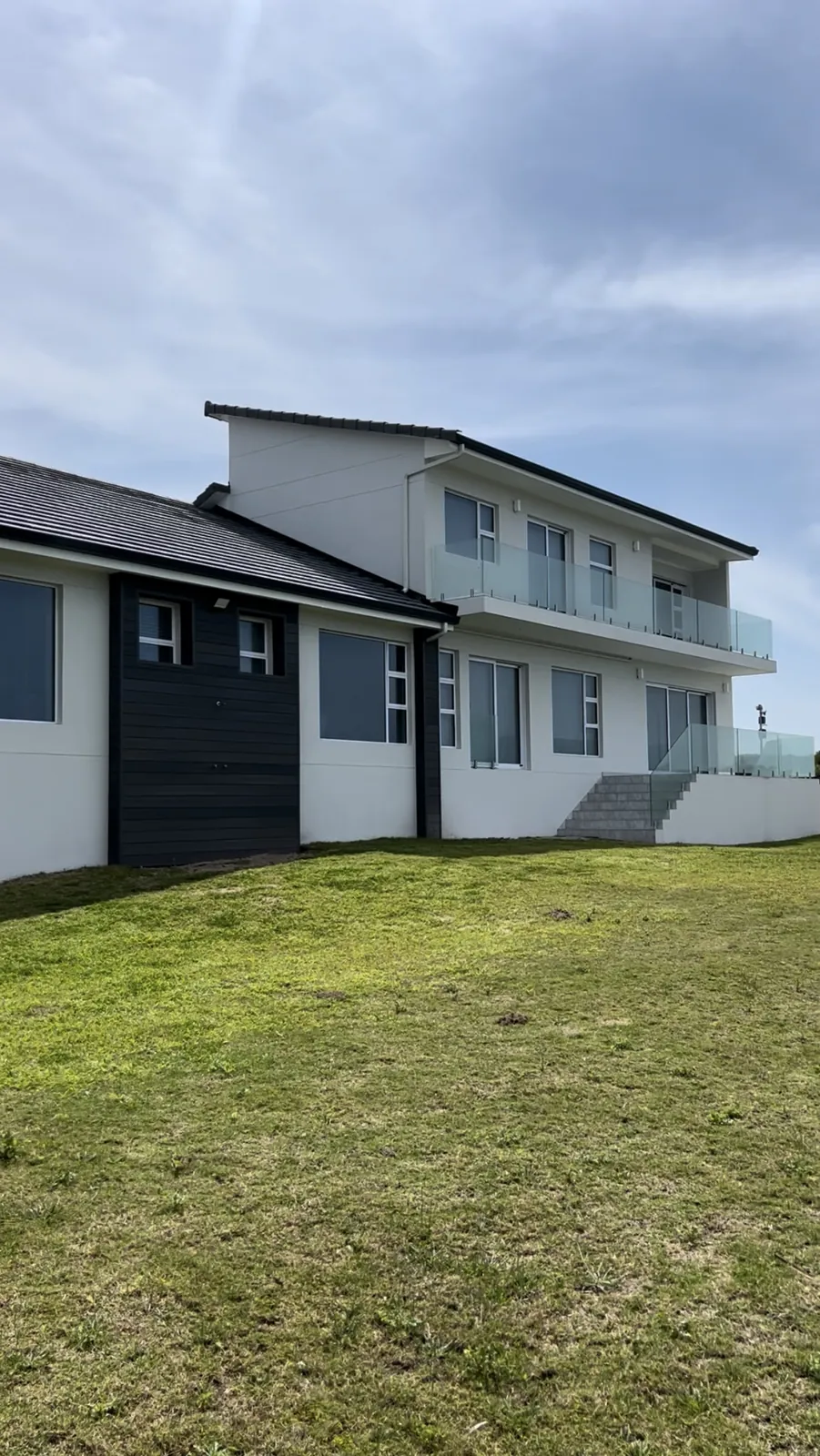 Restored double-storey home in Bayview, Mossel Bay, with frameless glass balustrades