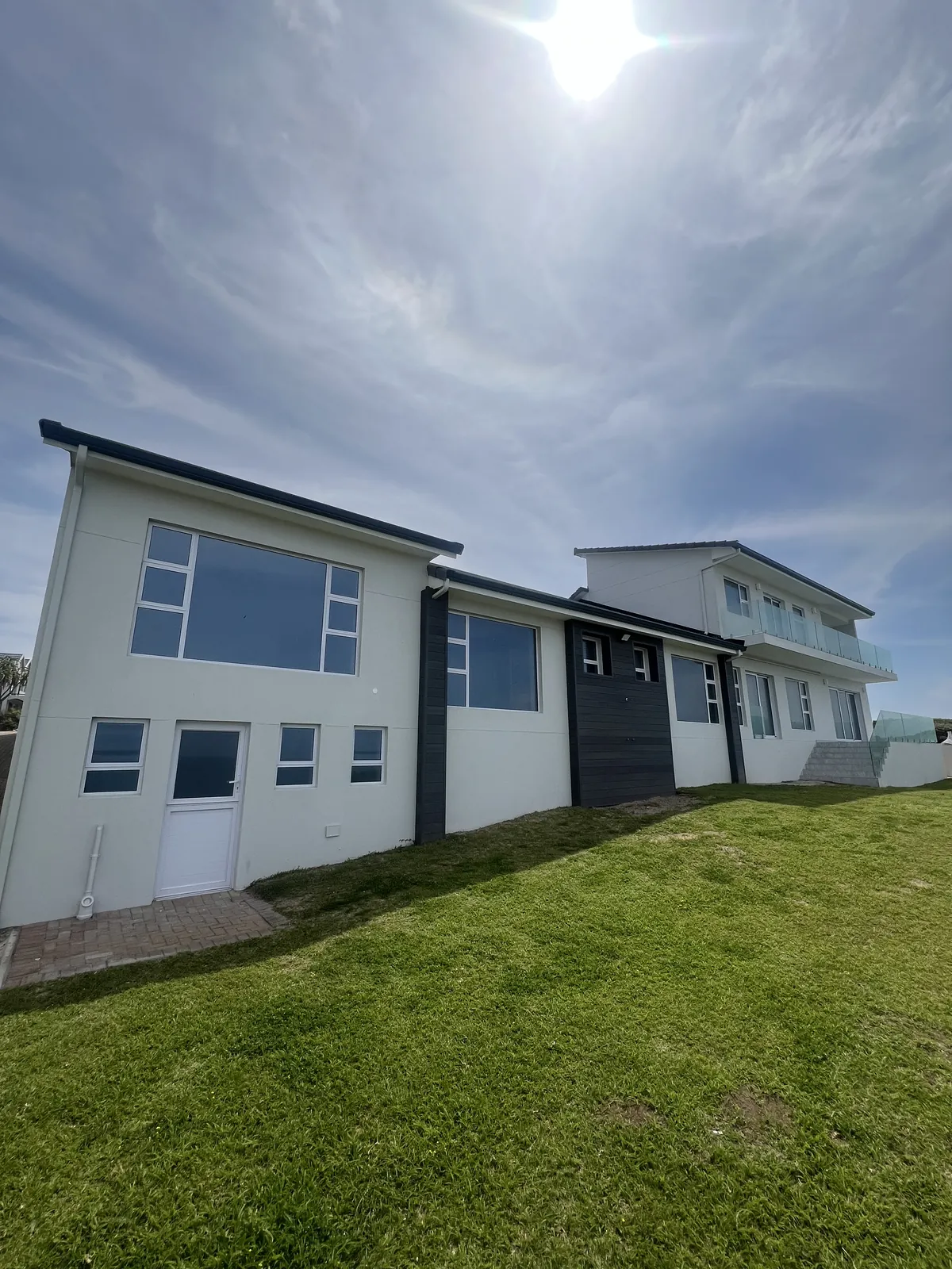 Back of the house from the garden, with new windows and dark cladding panels