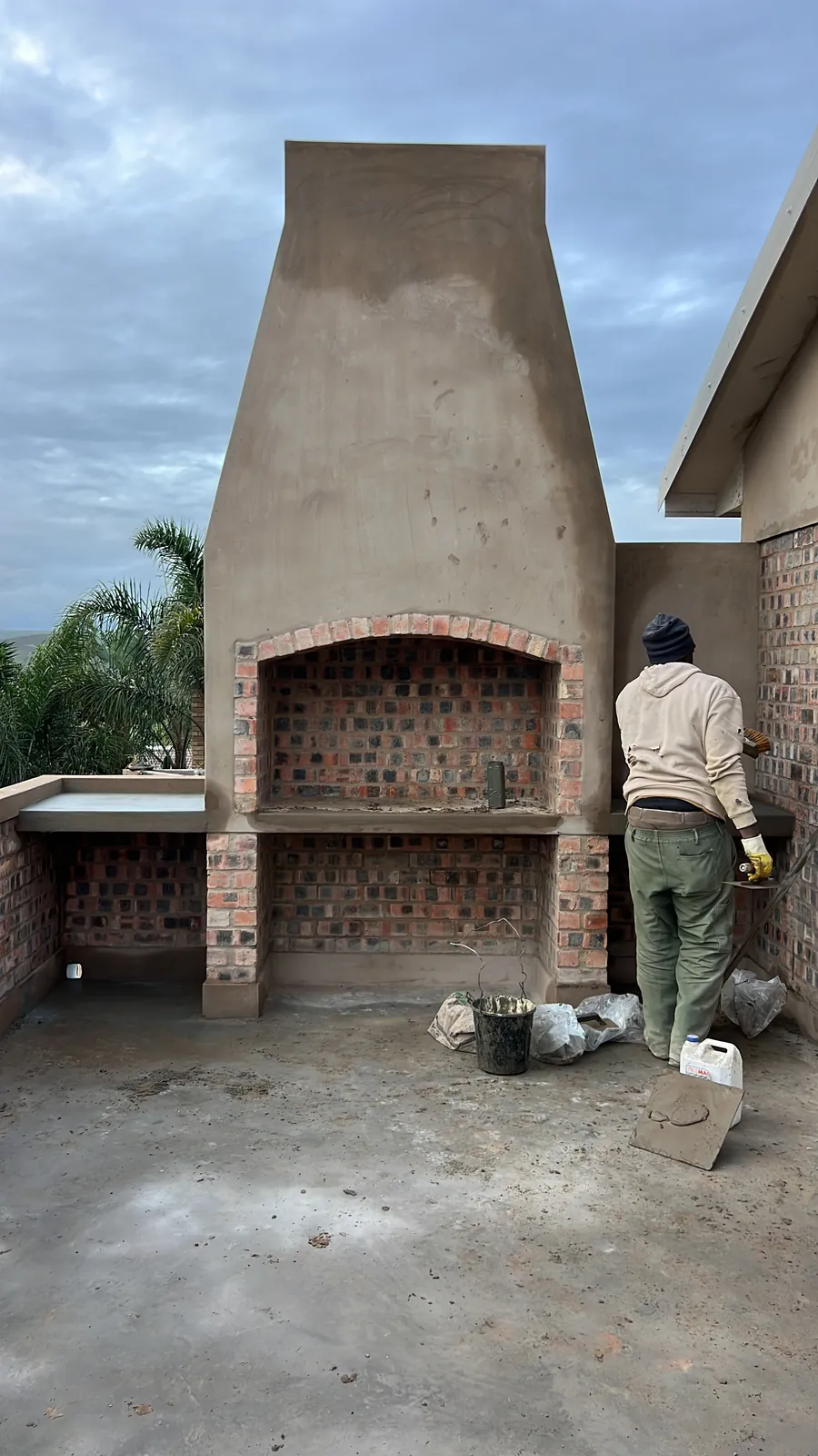 Plastering the balcony braai, with face-brick arch and alcove