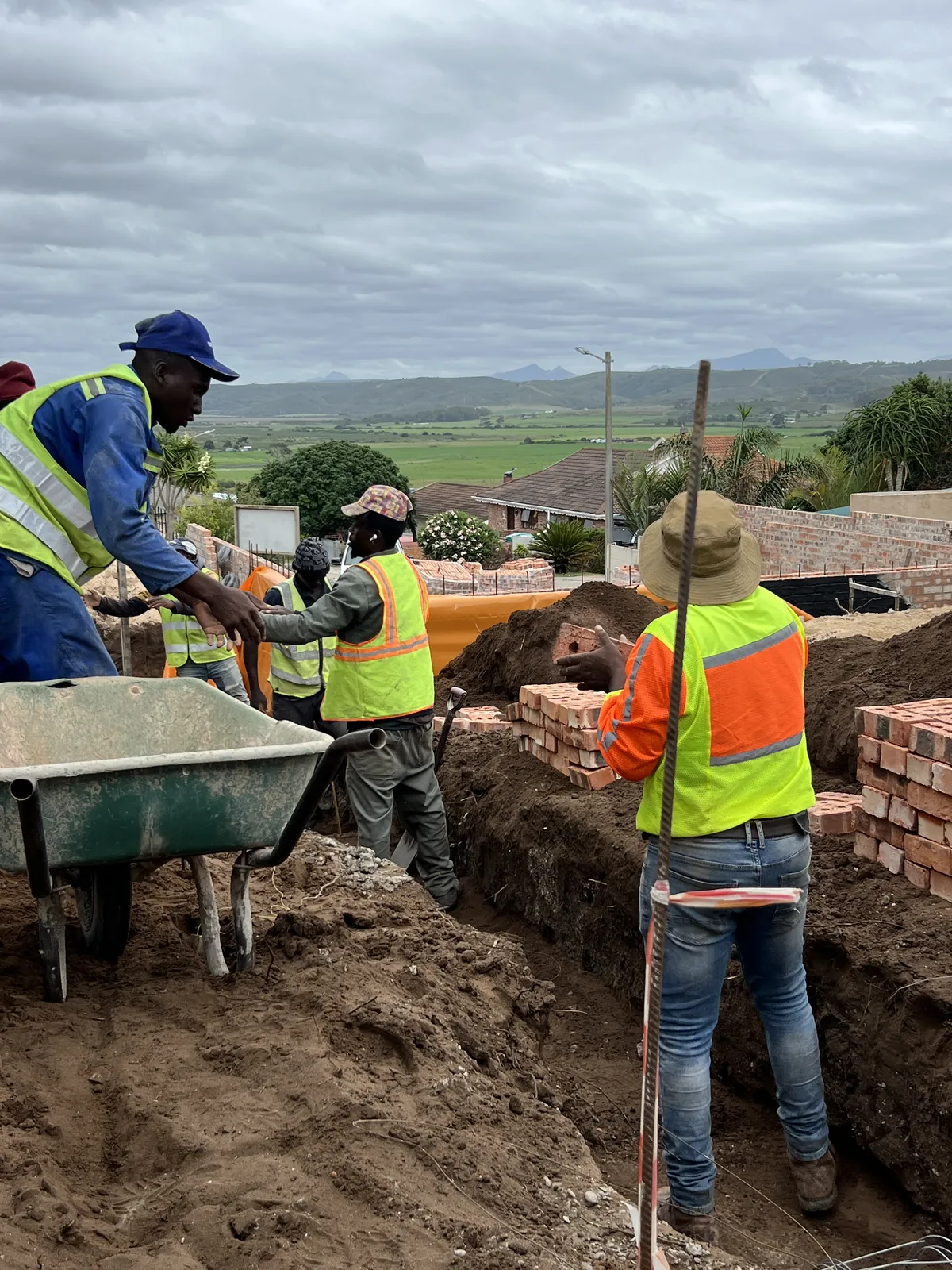 The team passing bricks down into the trenches