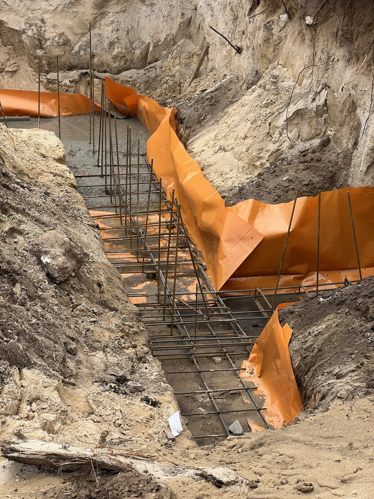 Reinforcing steel and damp-proof membrane in the foundation trenches