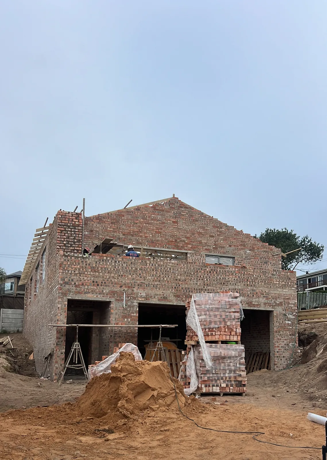 Brickwork up to the gables, with the first roof timbers going on