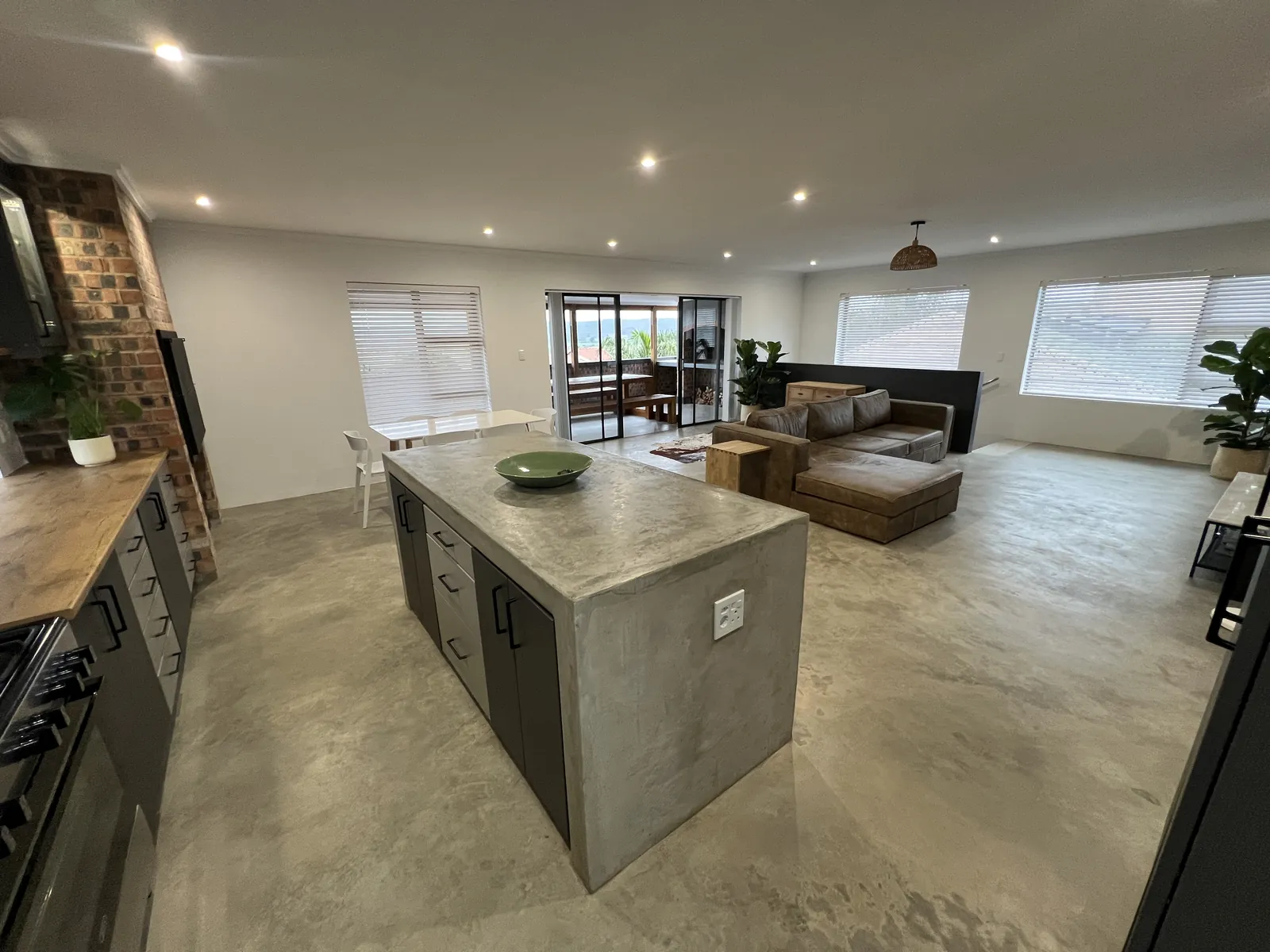 Kitchen with concrete island and view to the covered patio