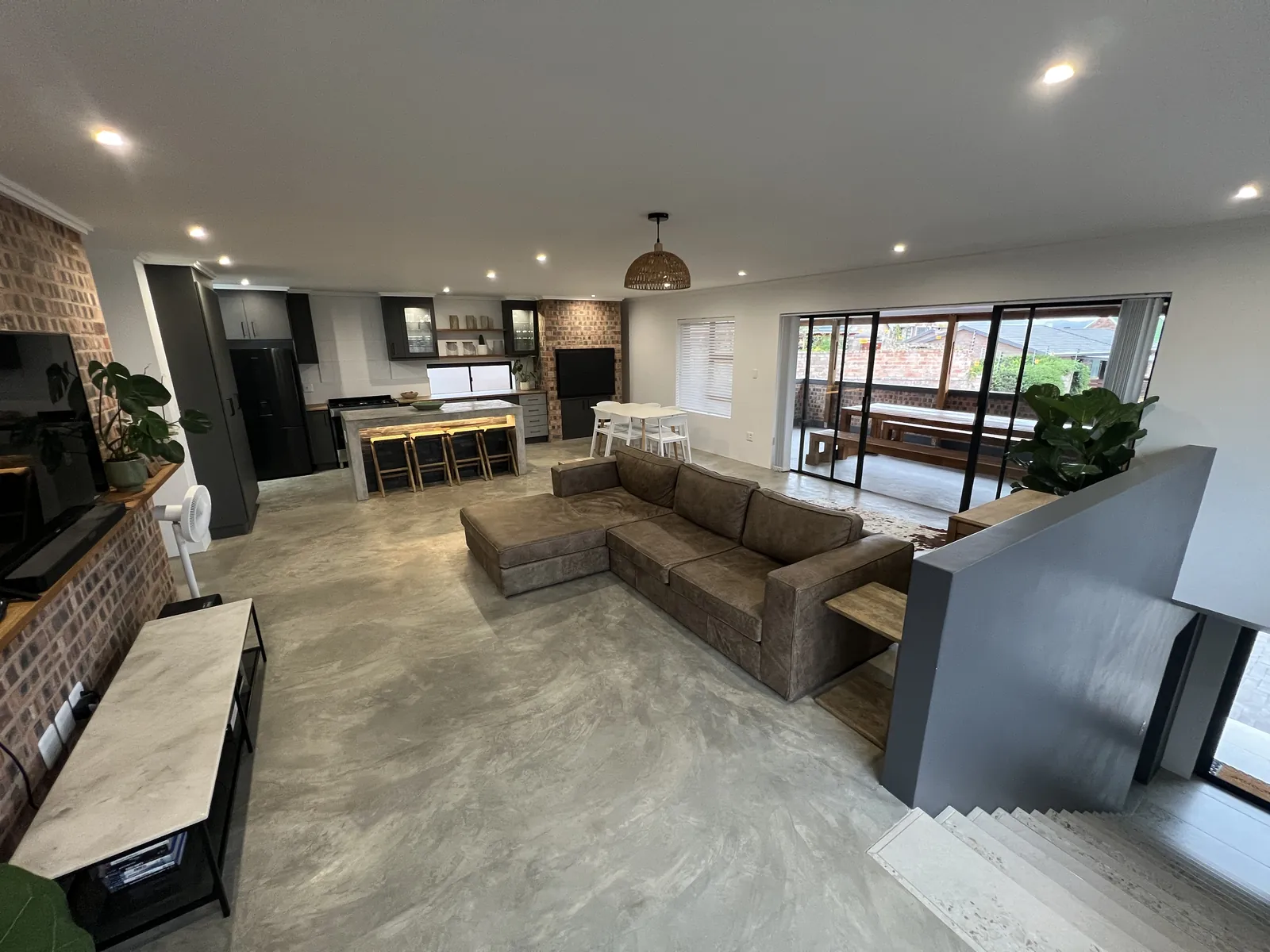 Open-plan upstairs living area with microcement floors