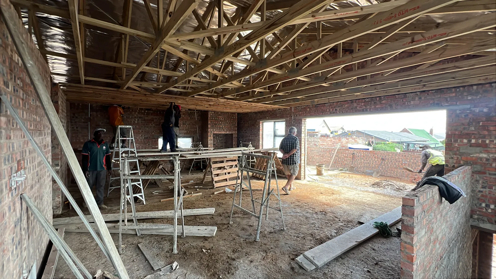 Jacques with the team as the roof timbers and ceiling battens go in