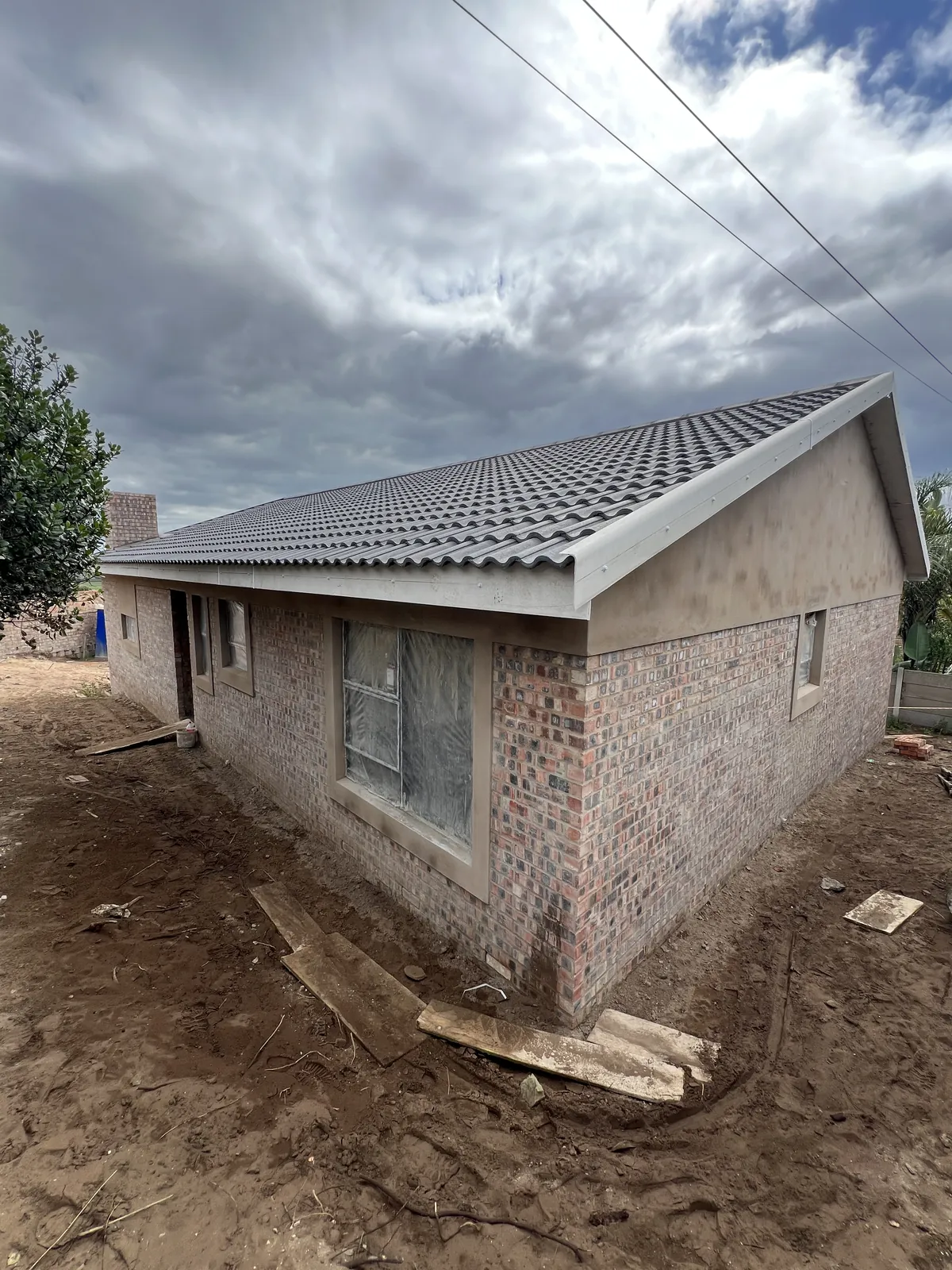Roof tiles on and window openings protected
