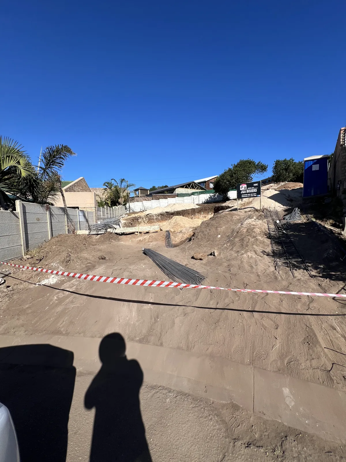 Day one: site cleared and taped off, with the J&A Bouers board up