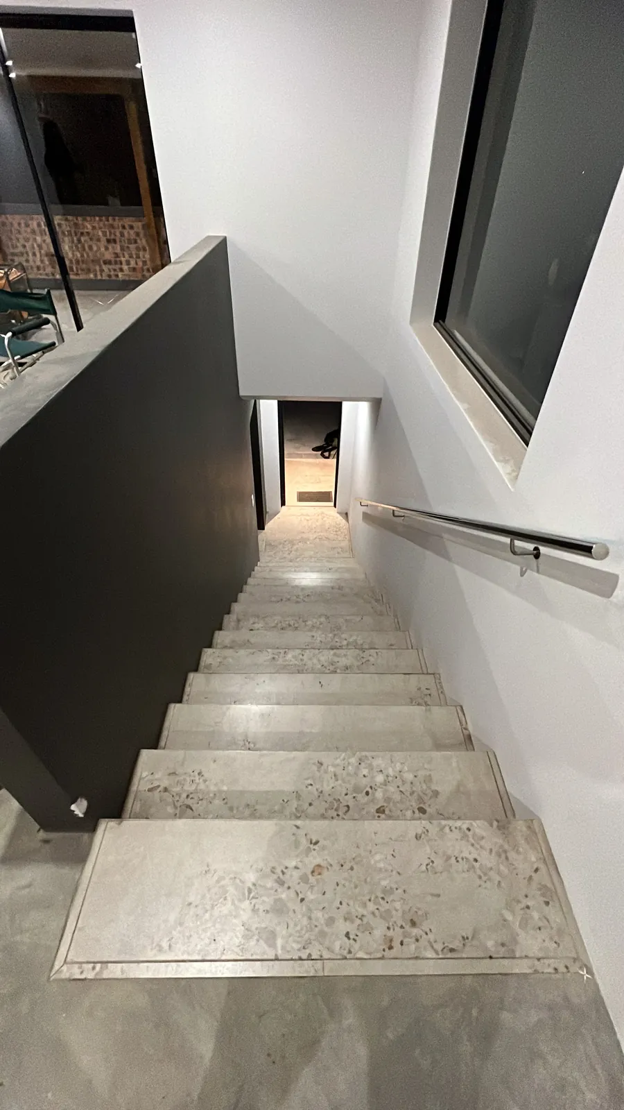 Tiled staircase with stainless steel handrail