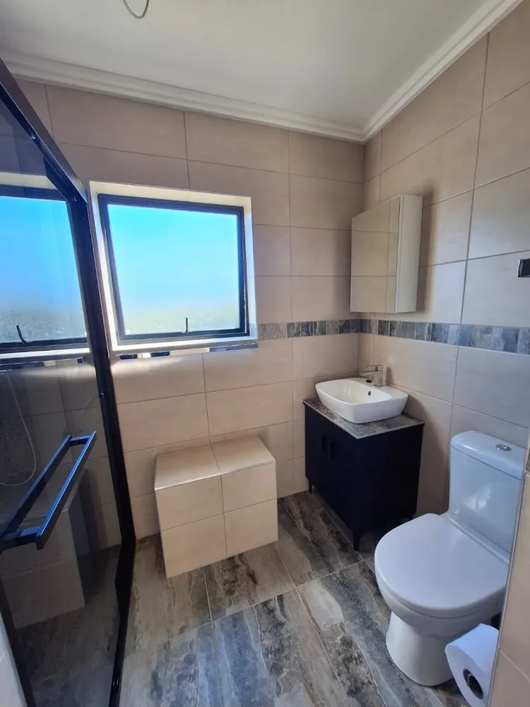New en-suite bathroom with tiled seat, vanity and walk-in shower