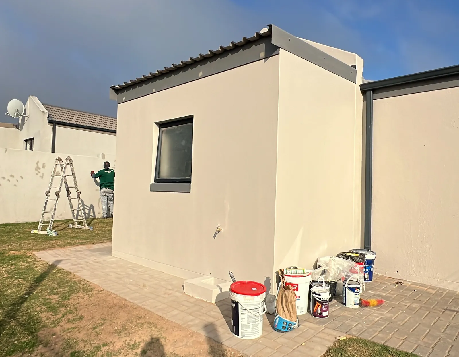 Painting the new walls to match, with the boundary wall touched up