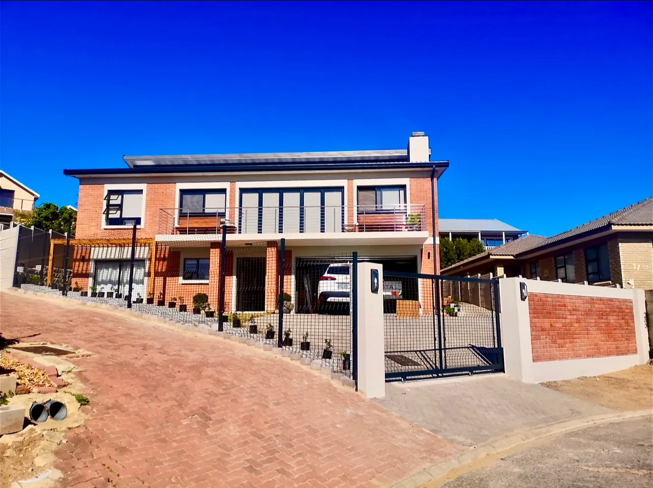 House Mooisig: a new double-storey face-brick home with a balcony, double garage and paved driveway