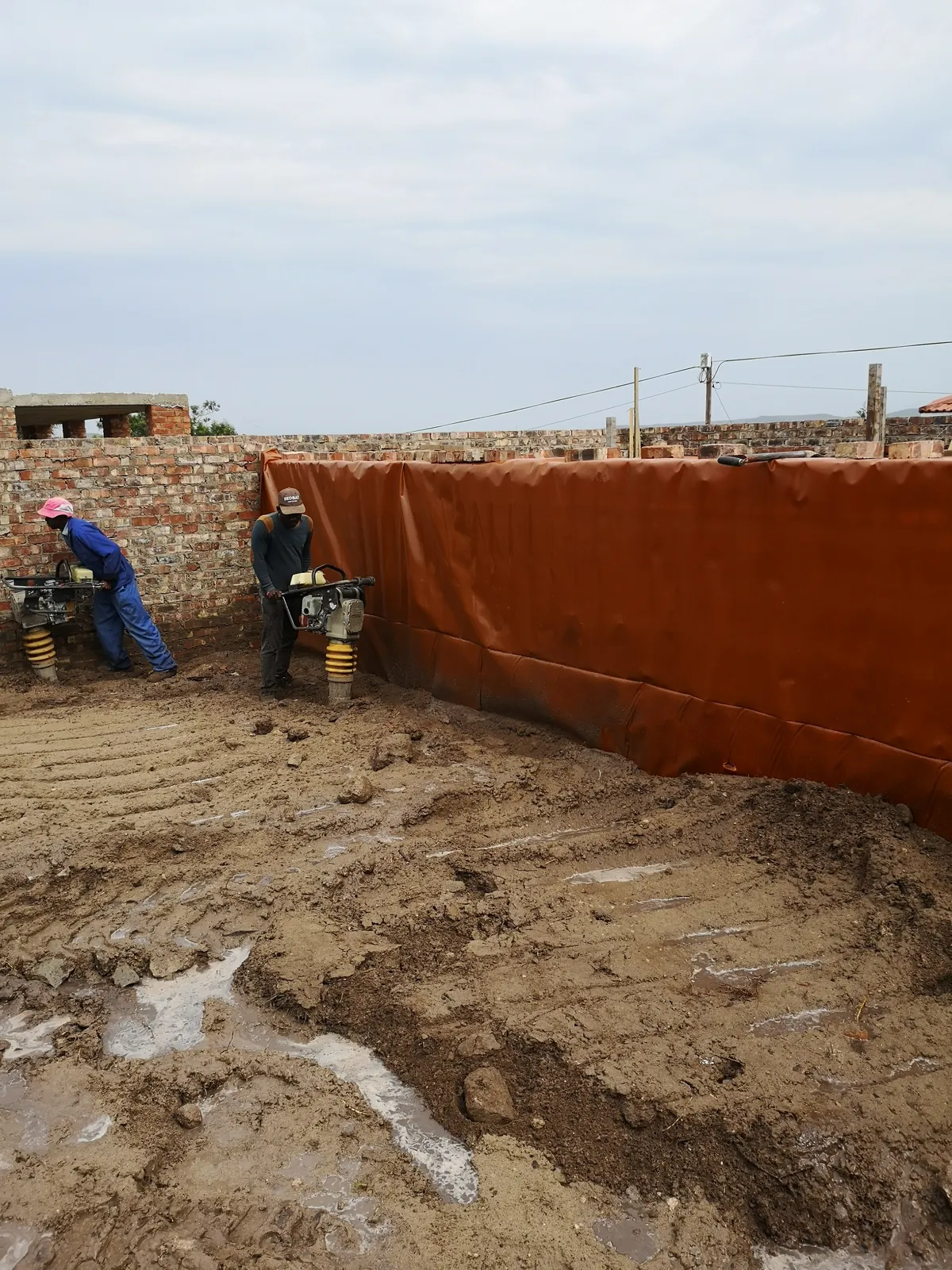 Compacting the fill against the damp-proof membrane