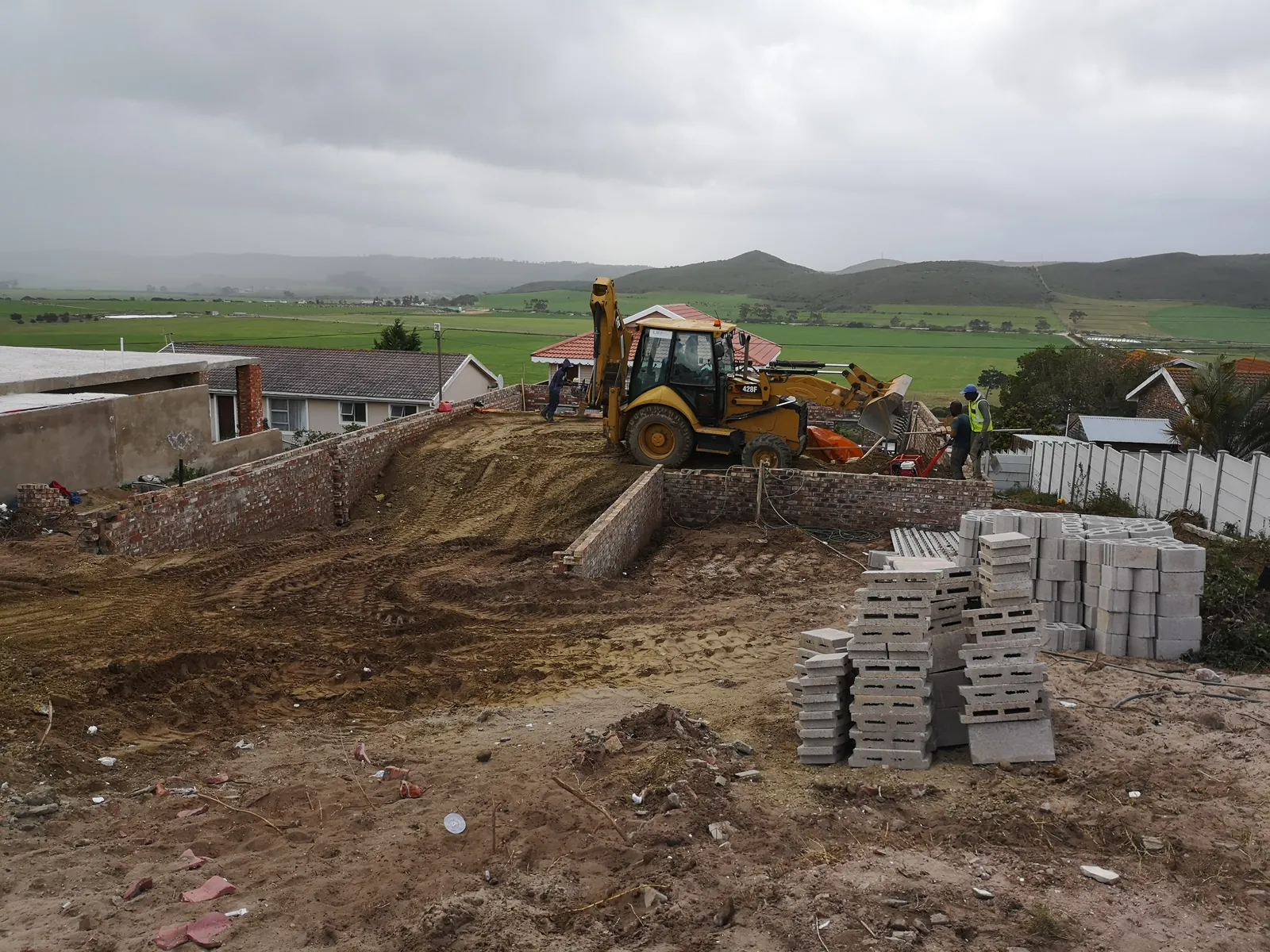 Earthworks and foundation walls on the sloping site, looking over the Klein-Brak valley