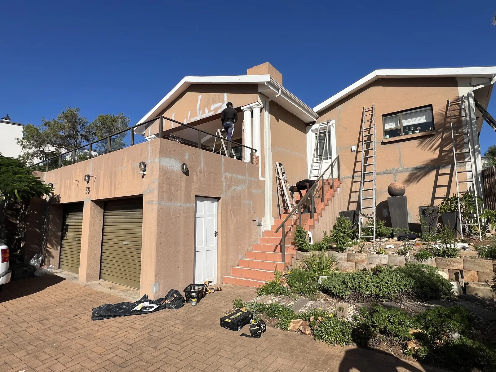 Ladders up and cracks filled across the walls before painting