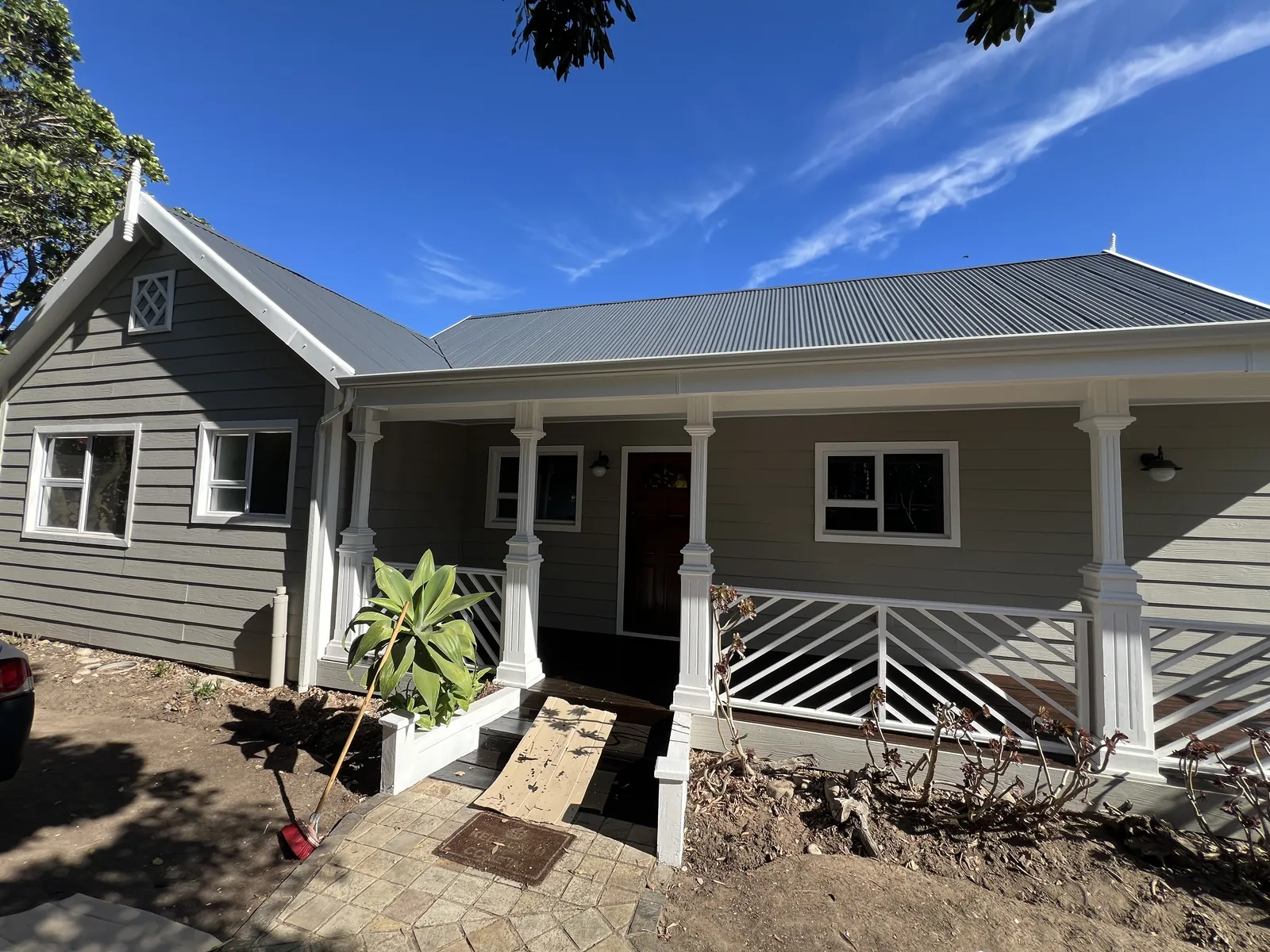 Repainted front of the house with white columns and veranda balustrades