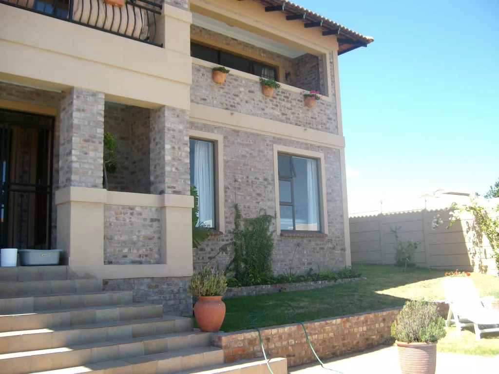 Front steps, brick columns and covered entrance