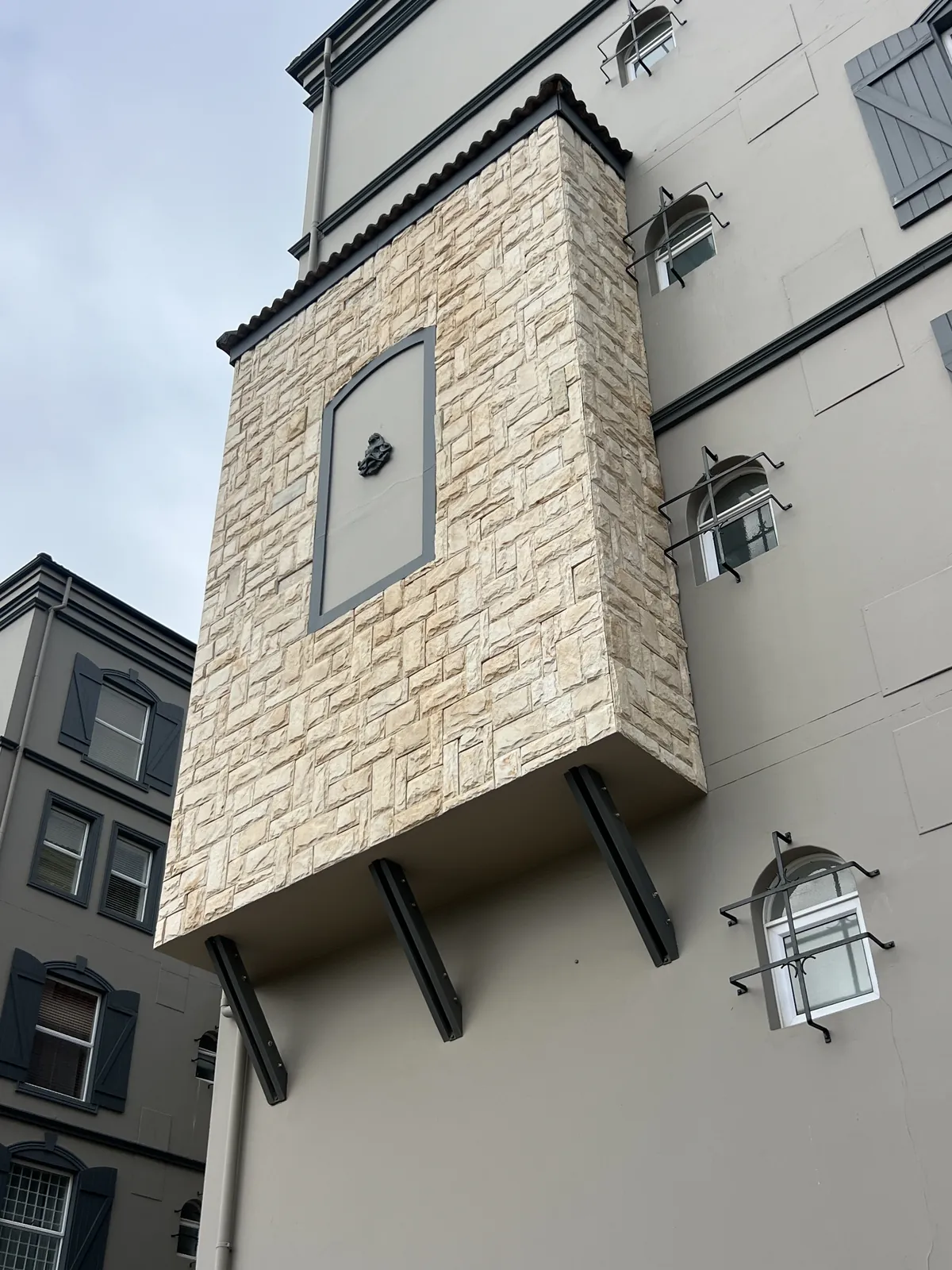 Before: the stone cladding on the second and third floors had started to come loose